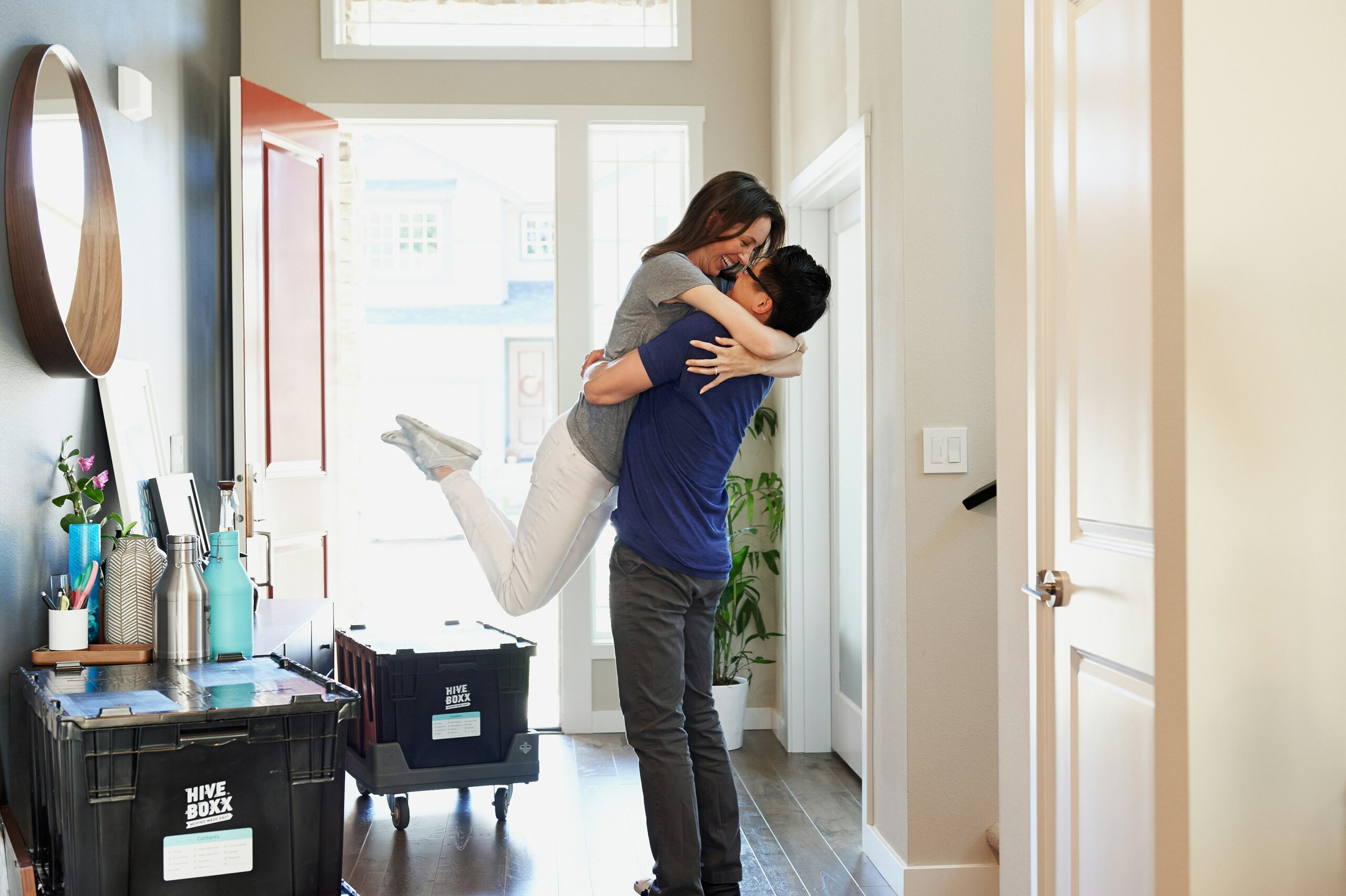 new home owners excited in their hallway